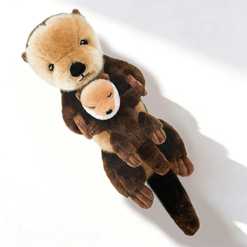 The ZoDoll Otter Plush Toy Soft Sea Otter Stuffed Animal (40x12cm) lies on a white surface, holding its removable baby plush on its chest.
