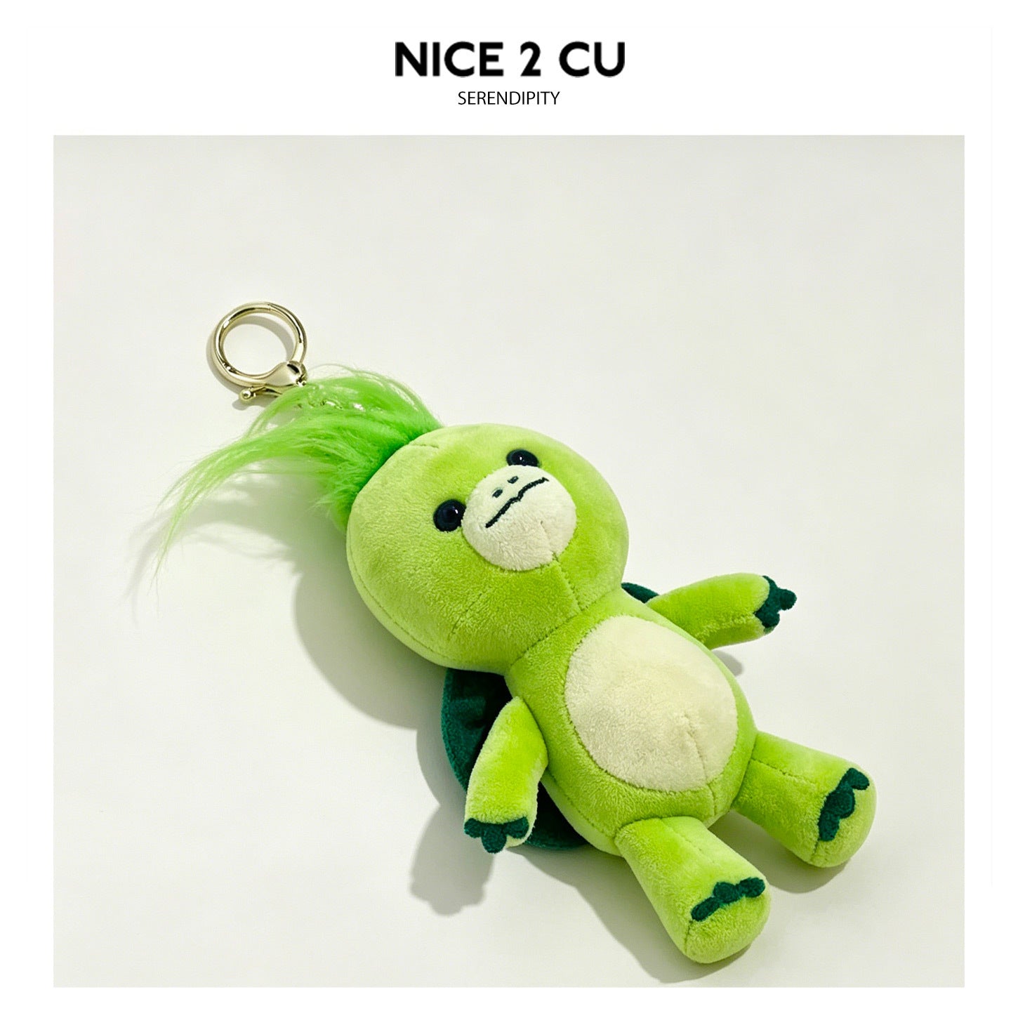 Lime-green kawaii turtle plush keychain charm with fluffy green hair tuft and gold lobster clasp