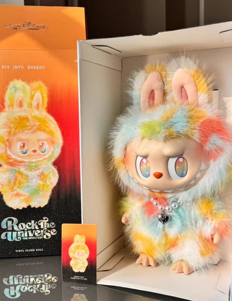 The Labubu Big into Energy Series Plush Doll – 37cm from POP MART features colorful rainbow fur and rabbit ears, standing in a box with matching artwork and a small card—ideal for any designer plush toy collection.