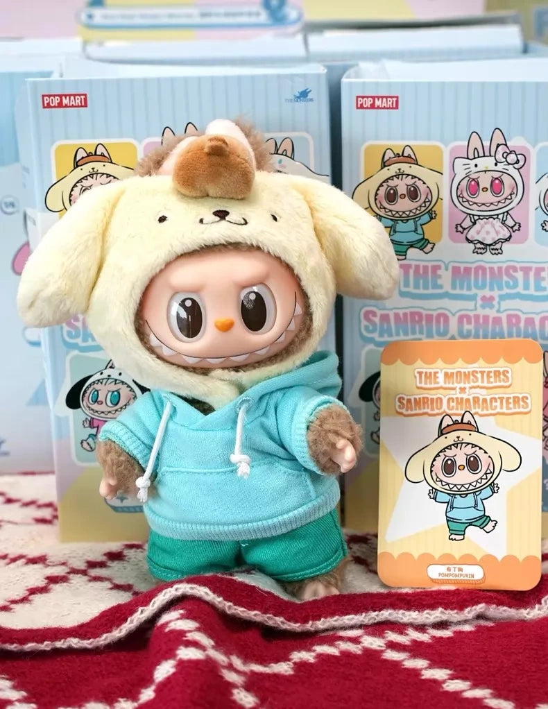 The POP MART LABUBU Hello Kitty and Friends Series Pompompurin Plush Pendant Figure is shown with its packaging and character card, displayed on a red-and-white patterned surface.