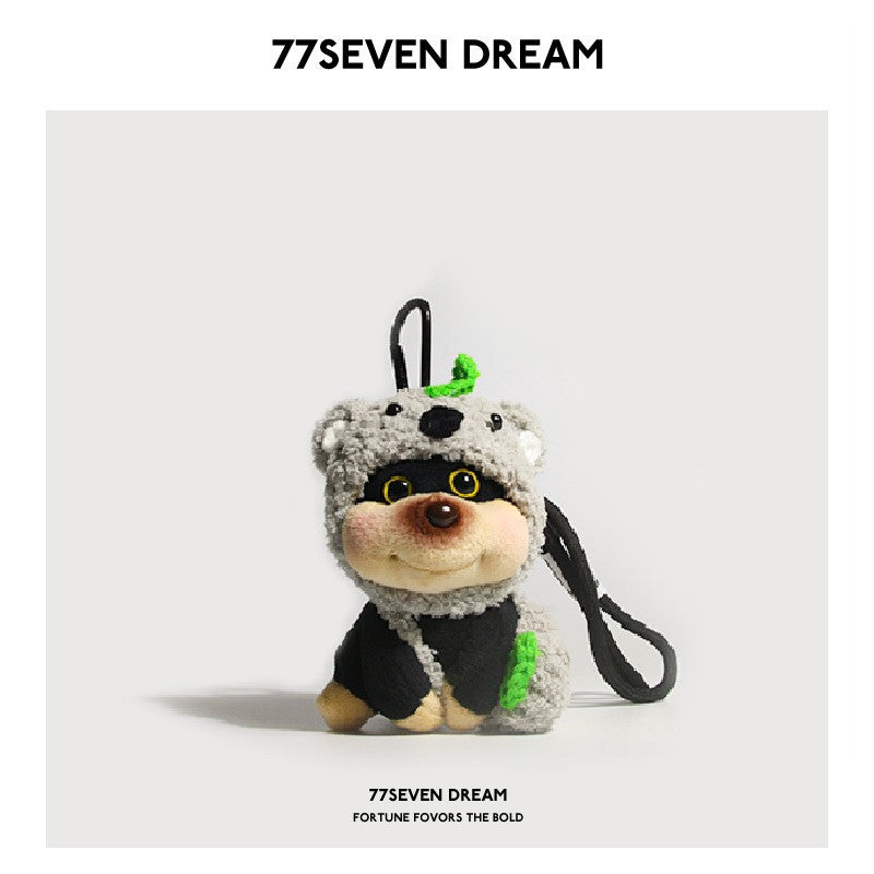 Chubby dog plush charm wearing a gray koala hood with green accents and a black hanging strap