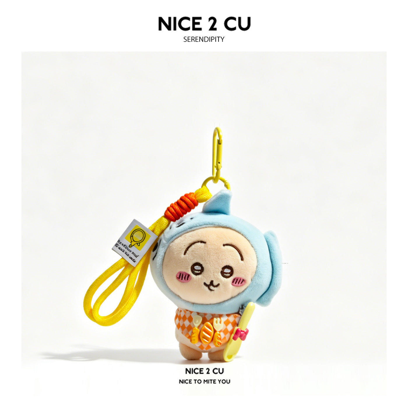 Kawaii chibi plush keychain charm wearing a light blue fish hood and orange argyle bib, with gold carabiner clip and hang tag