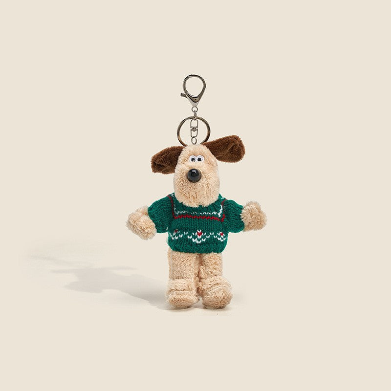 Long-fur cream dog plush charm wearing green knitted sweater with red and white stripes