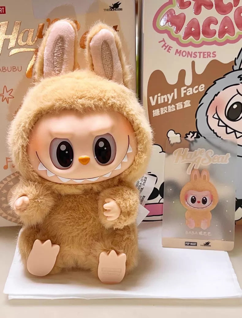 The Labubu “Baba” Plush Keychain – Have a Seat Series Brown Bunny by POP MART features a cute, large-eyed plush in a fuzzy brown bunny suit, with packaging and character card shown—an essential collectible for The Monsters fans.