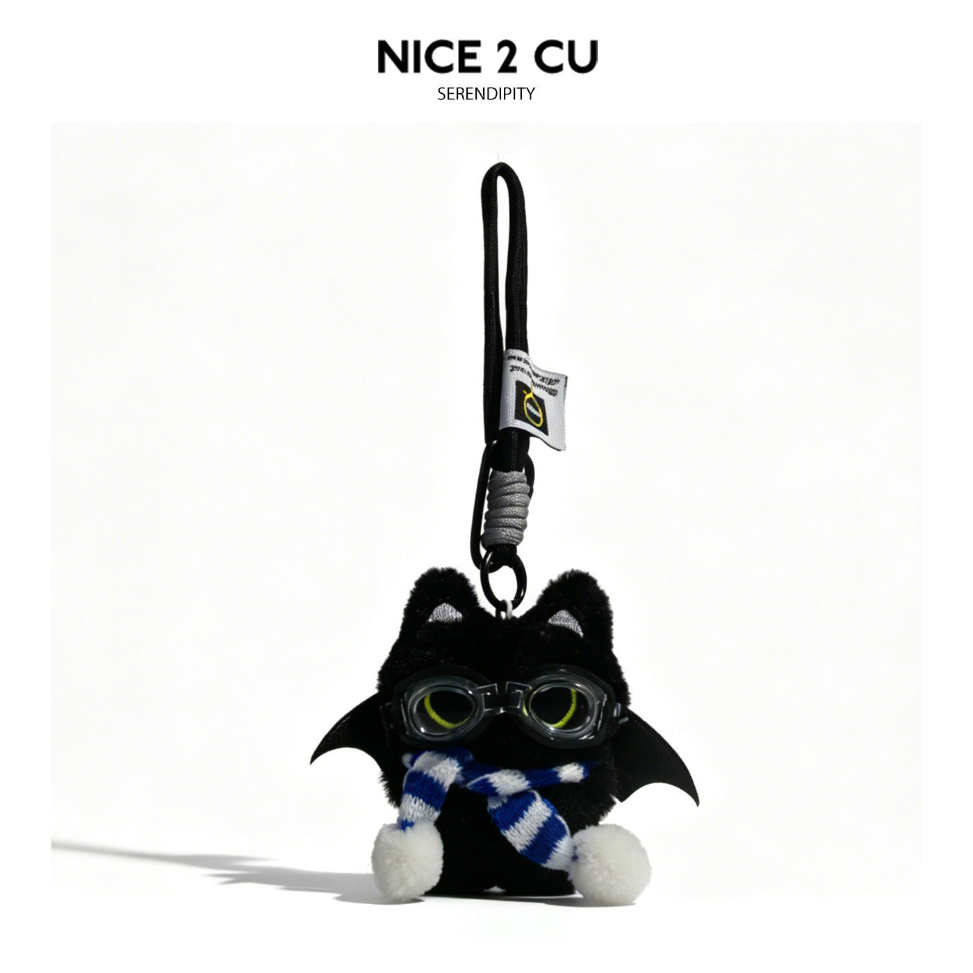 Black cat plush charm with bat wings, goggles, and blue-and-white striped scarf hanging from cord loop