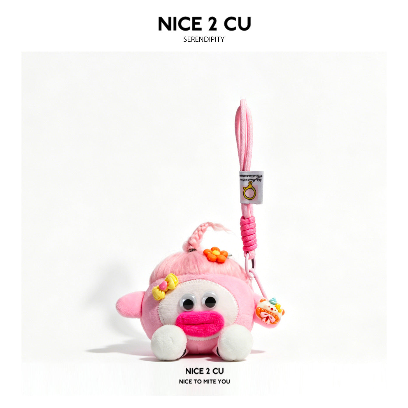 Pink kawaii plush charm keychain with pink braided top tuft, googly eyes, and decorative flower accent on pink hanging strap