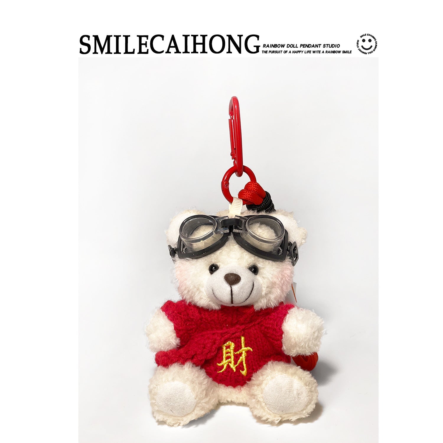 White plush teddy bear bag charm with red knitted outfit embroidered with yellow 財 character and black goggles