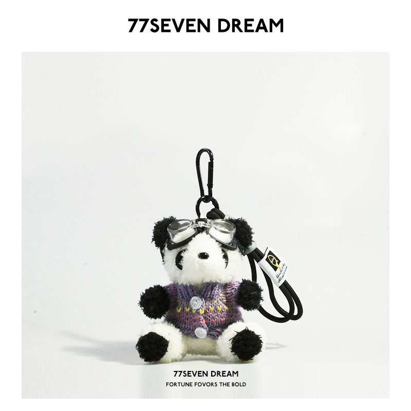 Panda plush charm in purple knitted sweater with button accents and clear aviator goggles