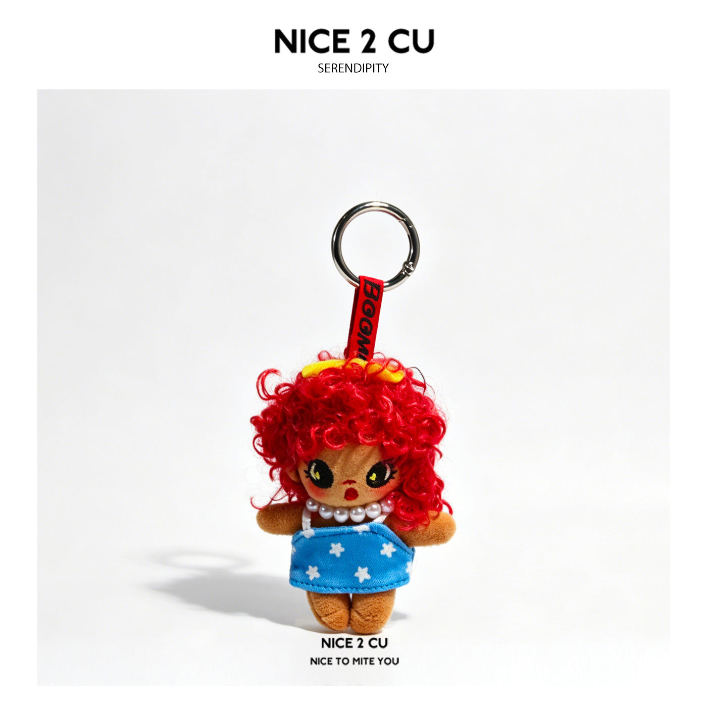 Grumpy girl plush doll keychain charm with curly red hair and blue star-print dress on red woven strap