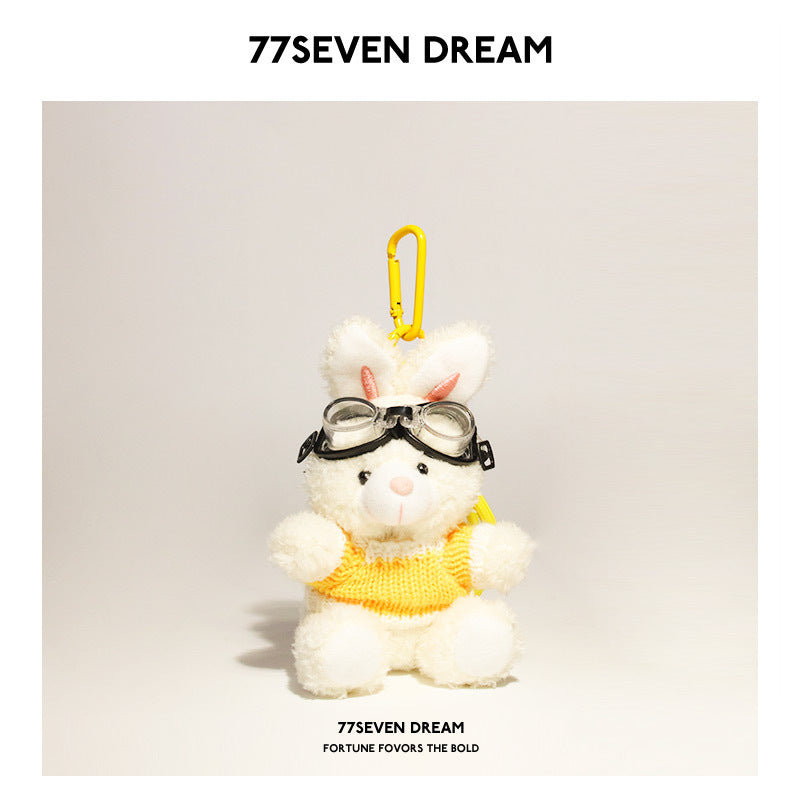 White rabbit plush keychain wearing yellow-and-white knit sweater and goggles with yellow hanging clip