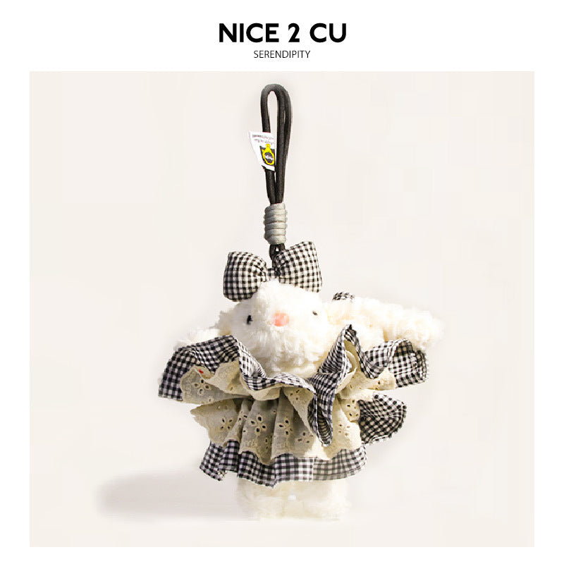 White plush rabbit charm dressed in black-and-white checkered ruffled dress with matching bow and dark hanging loop