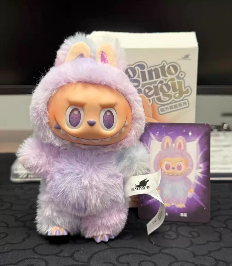 The Labubu “Luck” Plush Keychain – The Monsters “Big Into Energy” Series Pastel Bunny Bag Charm by POP MART features a mischievous face in a purple and white bunny costume, shown with its illustrated box and matching card.