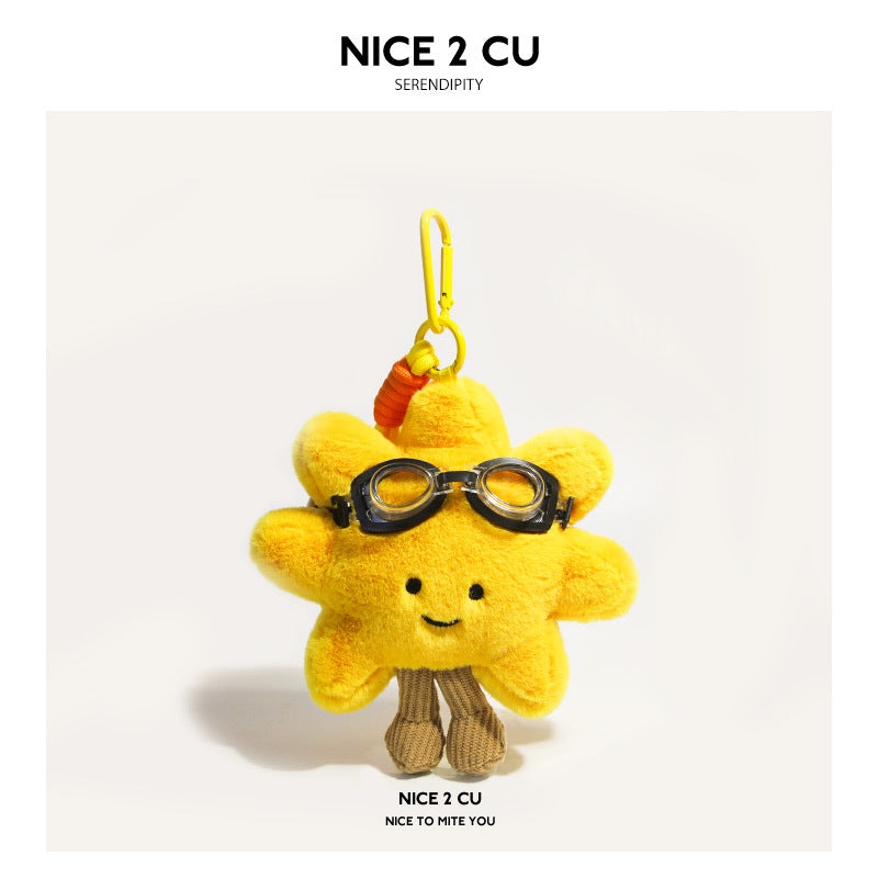 Yellow sunflower plush charm with black toy goggles and yellow cord strap attachment