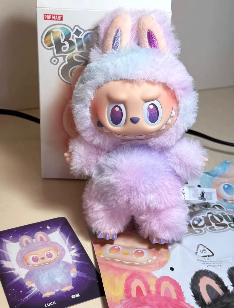 The POP MART Labubu “Luck” Plush Keychain from The Monsters “Big Into Energy” Series is a pastel bunny bag charm with large eyes, shown with its box and matching illustrated card—an adorable collectible for any fan.