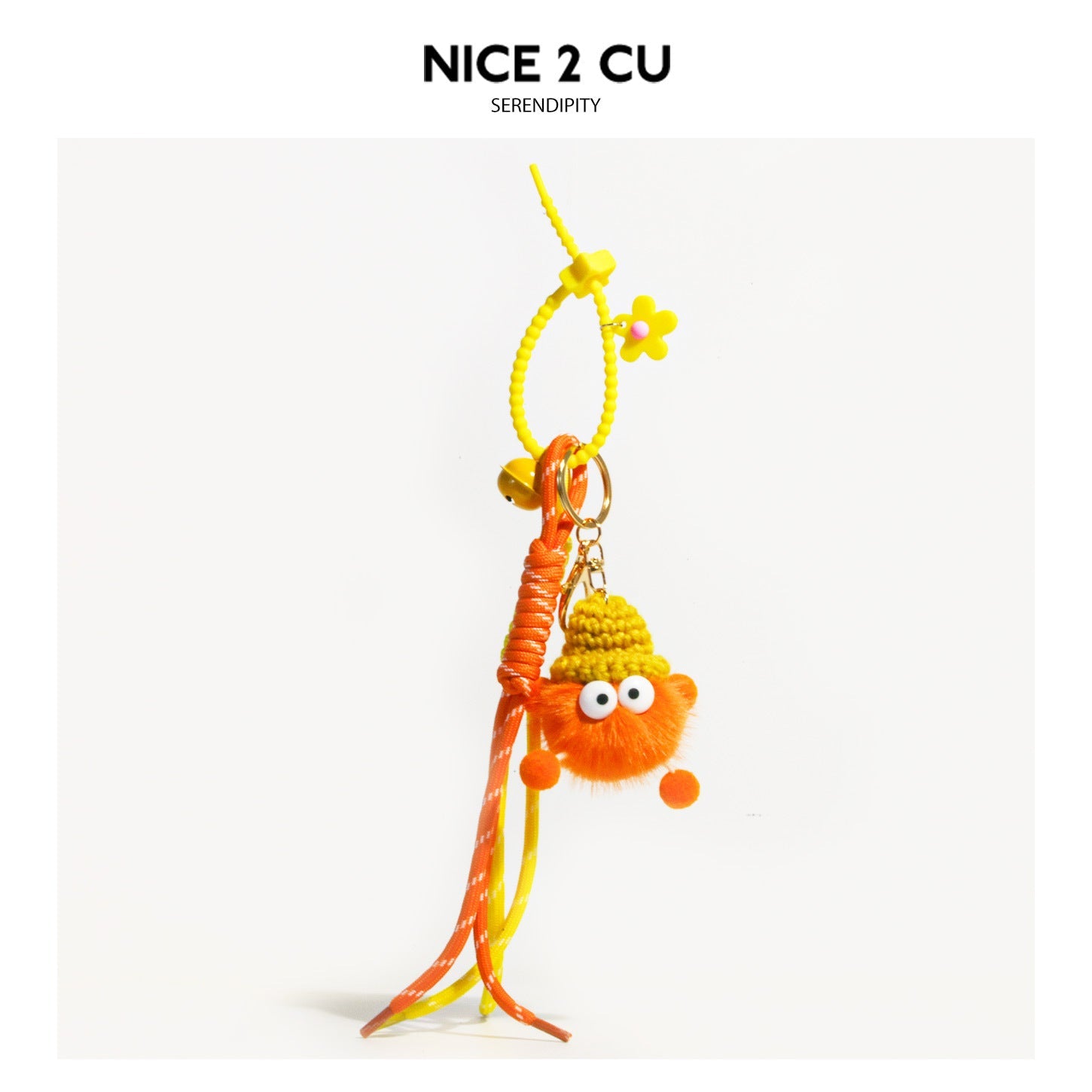 Orange fluffy googly-eye character charm with yellow crocheted hat, yellow flower bead with pink center, and orange-yellow br