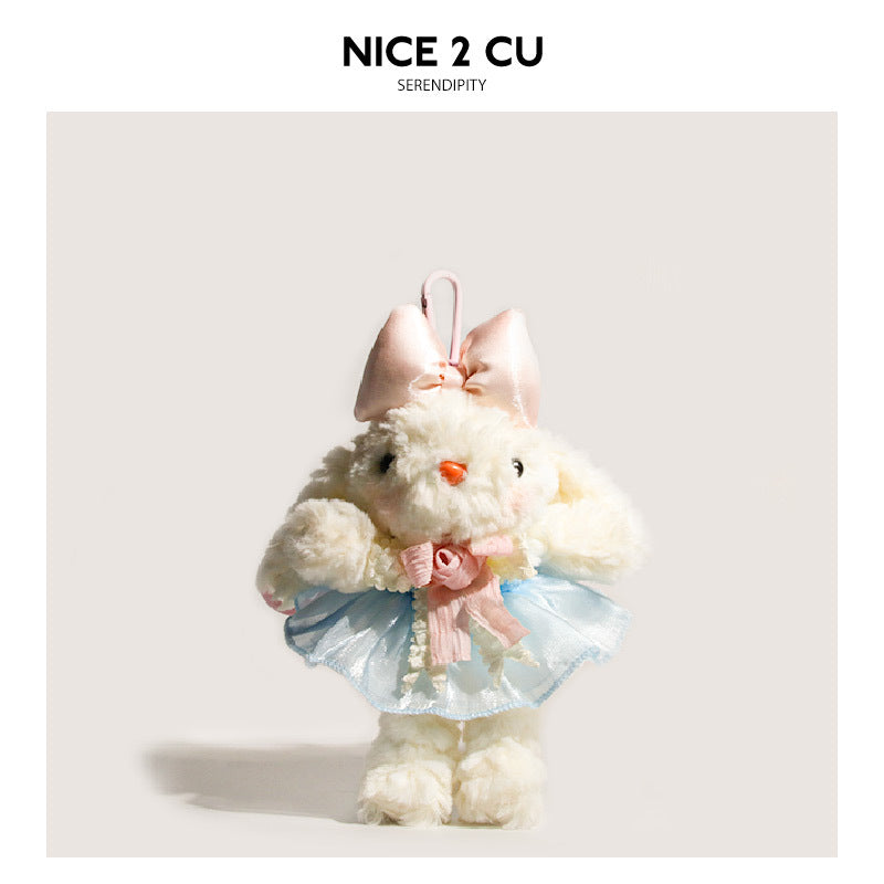 White bunny plush bag charm wearing a pale pink bow and light blue tulle skirt with pink waist ribbon