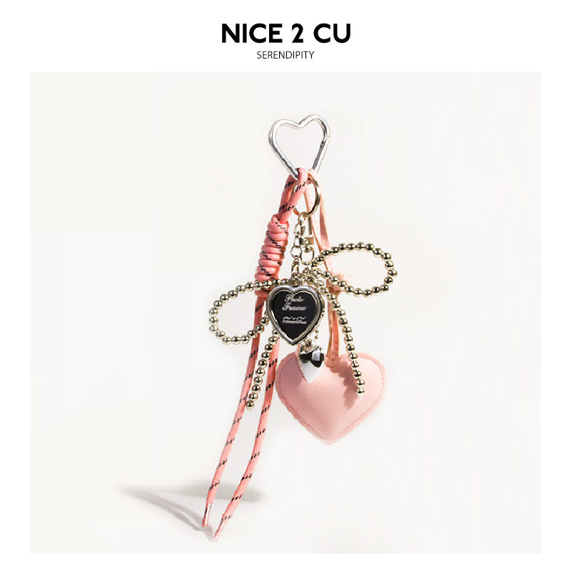 Pink heart bag charm with silver heart carabiner clip and gold bead chain bow detail
