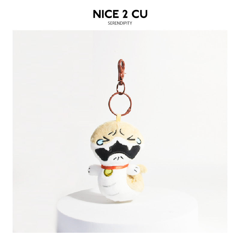 Cartoon dog plush keychain charm with sobbing crying face, red collar with gold bell, and rose-gold lobster clasp