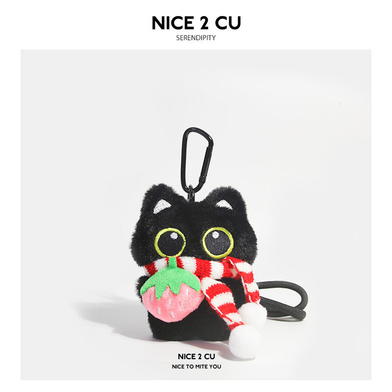 Black cat plush charm wearing a red-and-white striped scarf and holding a pink strawberry