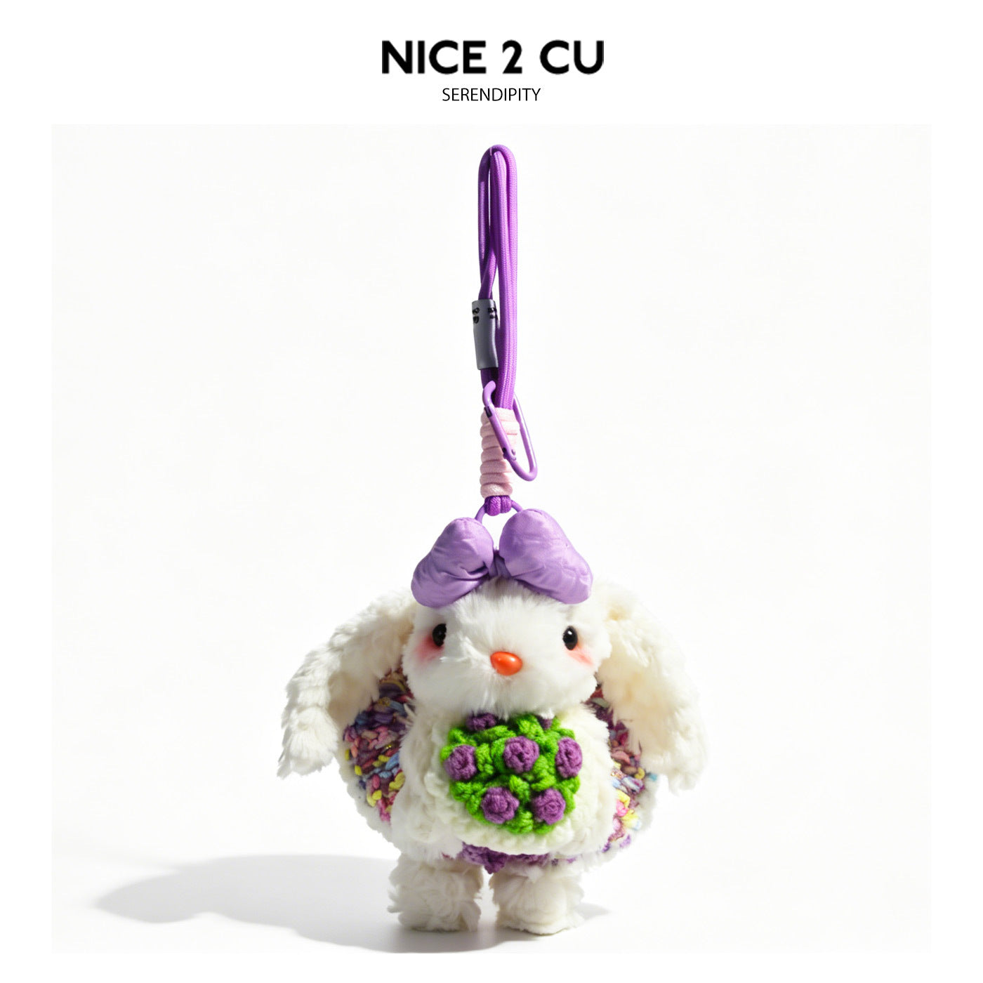 White lop-eared bunny plush keychain with purple bow, multicolor knit outfit, and crochet purple flower bouquet