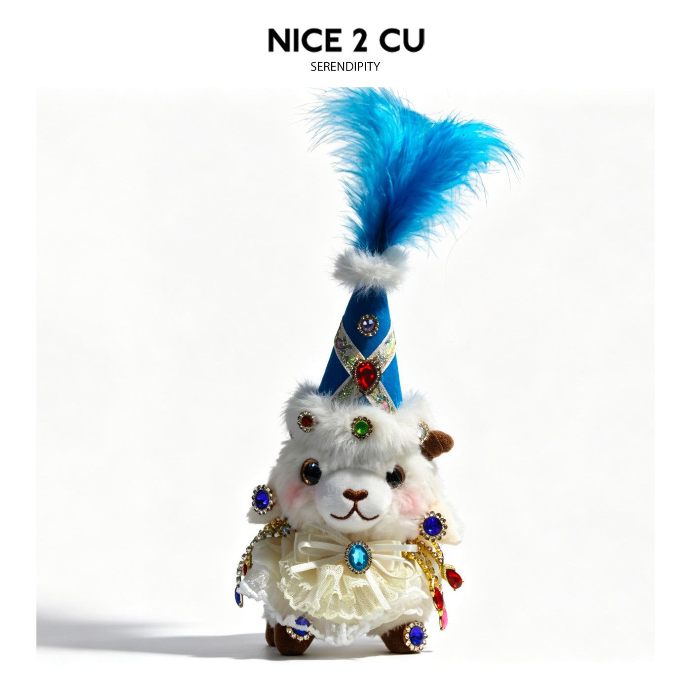 Blue-themed plush lamb figurine with tall blue feathered hat, silver trim, and multicolored jewel-like embellishments