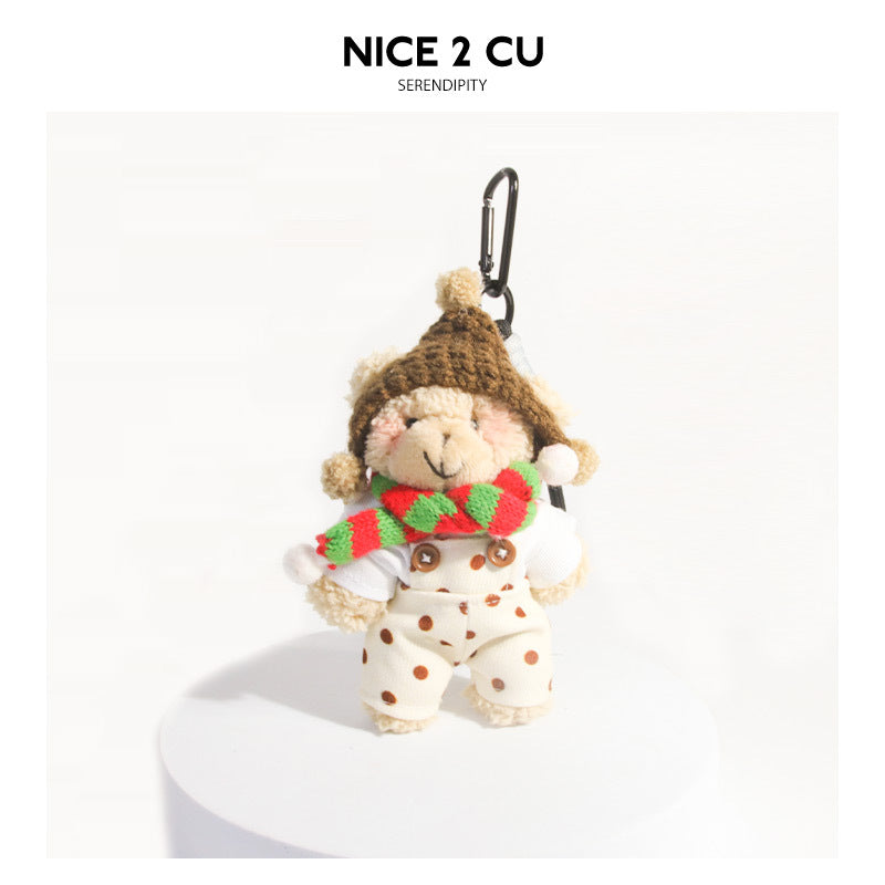 Khaki plush bear bag charm with green-red striped scarf, brown knit hat, and polka-dot overalls, black clip