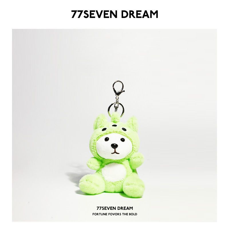 Green plush bear keychain charm with three-dot forehead detail in a bright green hooded outfit
