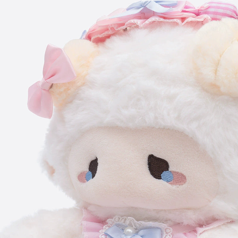 A close-up of the ZEIO Fashion Sheep Plush Toy 29cm—a collectible lamb doll with white fur, pink bow, sad embroidered eyes, and a pink and blue bonnet.