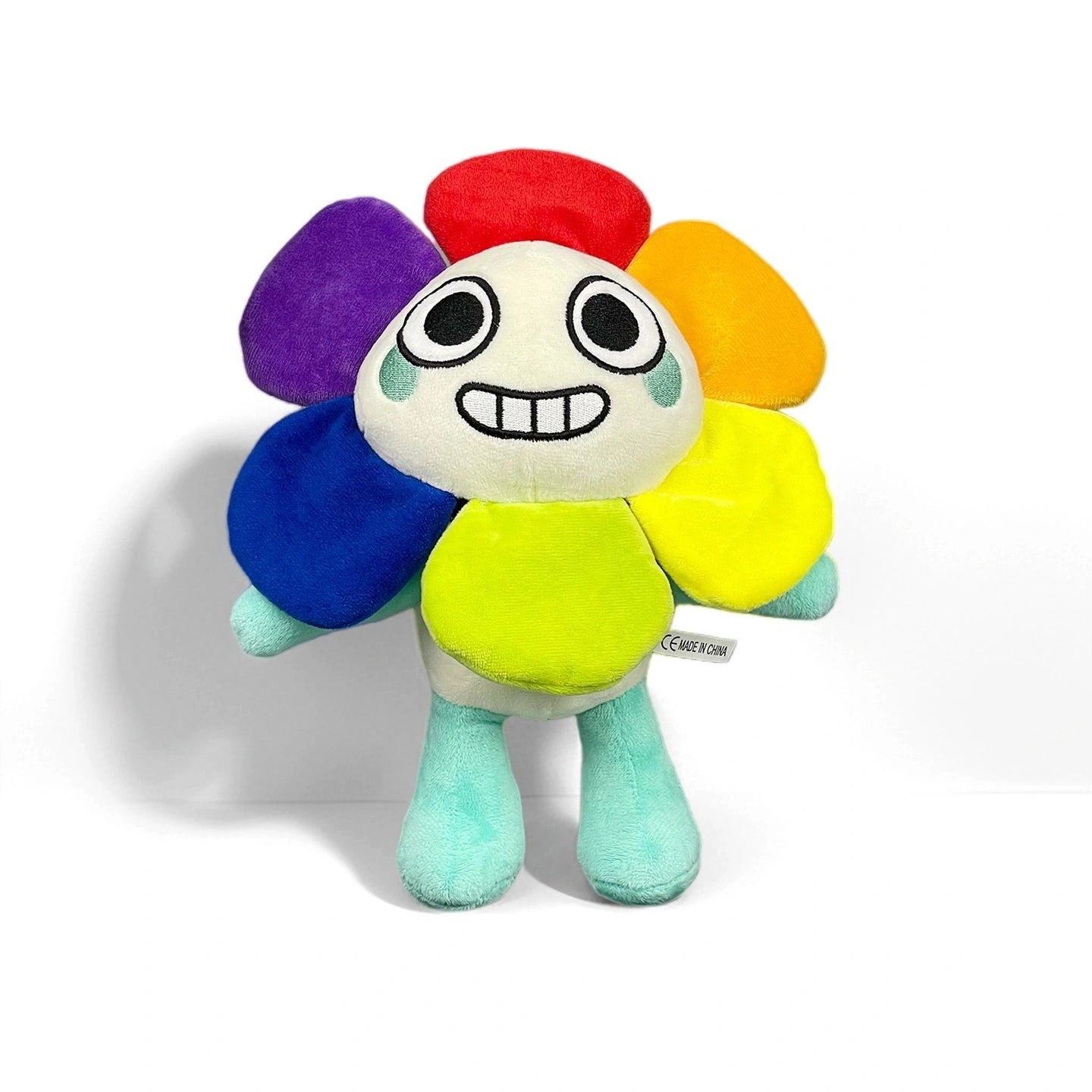 A Dandy's World Plush Collection character from Dandy's World features a smiling face, round eyes, and multicolored flower petal hair, standing upright. Soft stuffed toys sold individually; multiple characters available.