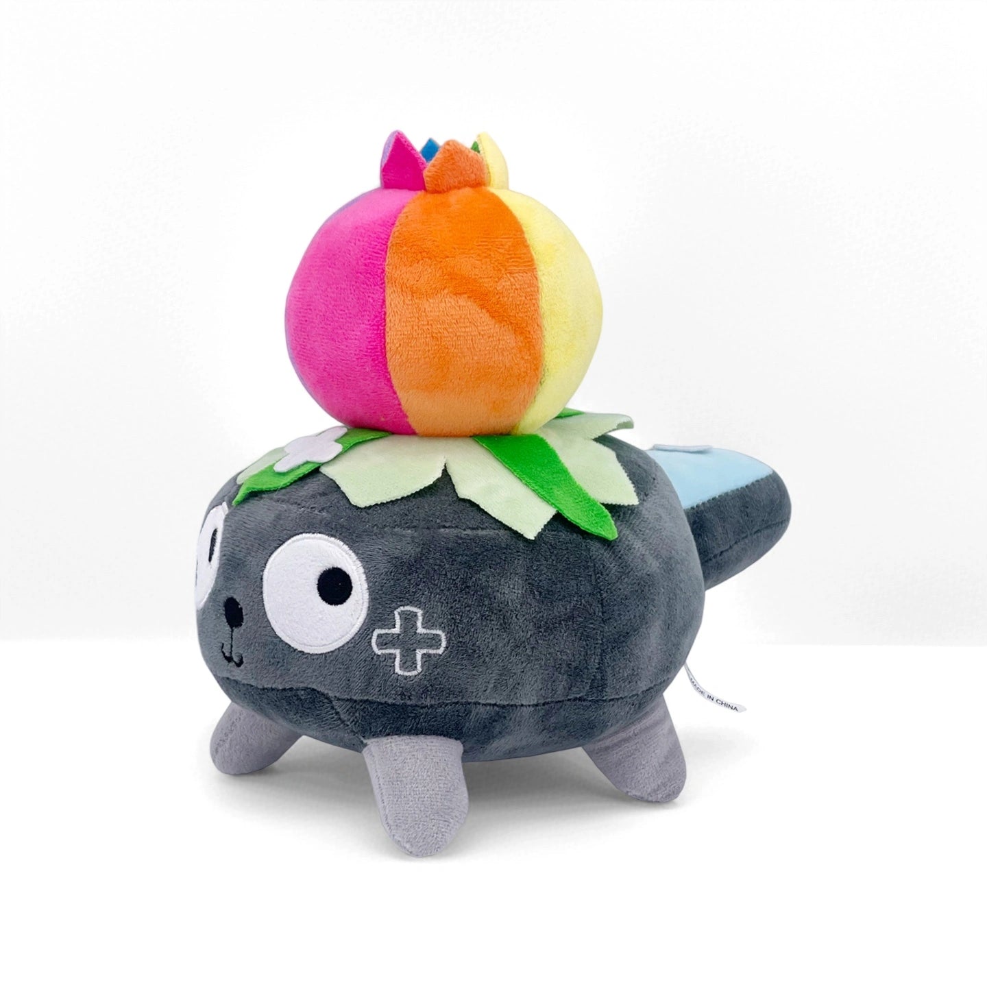 The Dandy's World Plush Collection by Dandy's World features individually sold, soft stuffed toys—like a gray character with a cross-shaped eye, green leaf top, and colorful plush detail—perfect for fans and plush collectors.