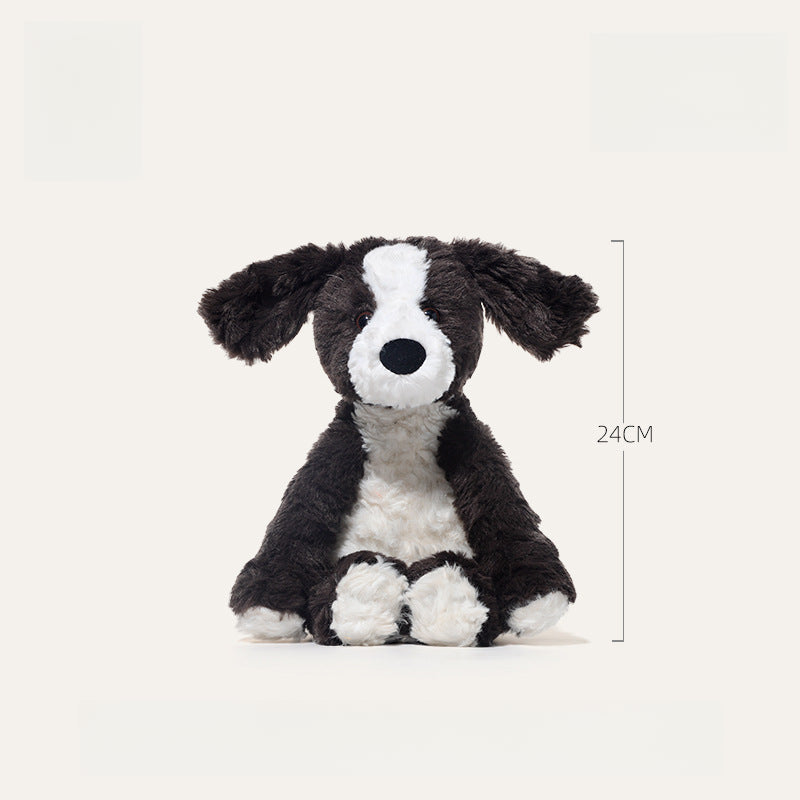 The JOOKI 24cm Black and White Puppy Plush Toy is a soft stuffed dog with floppy ears, sitting upright and measuring 24 centimeters tall.