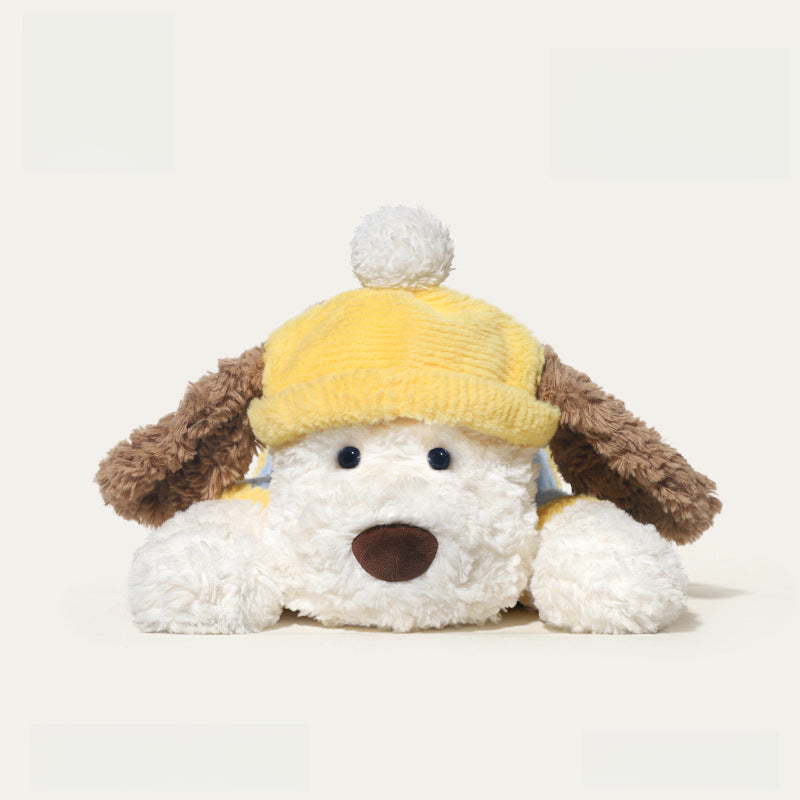 The JOOKI 44cm Lying Dog Plush Toy features a soft stuffed puppy with brown ears, a white body, and a yellow hat with a white pom-pom—perfect for kids or decor.