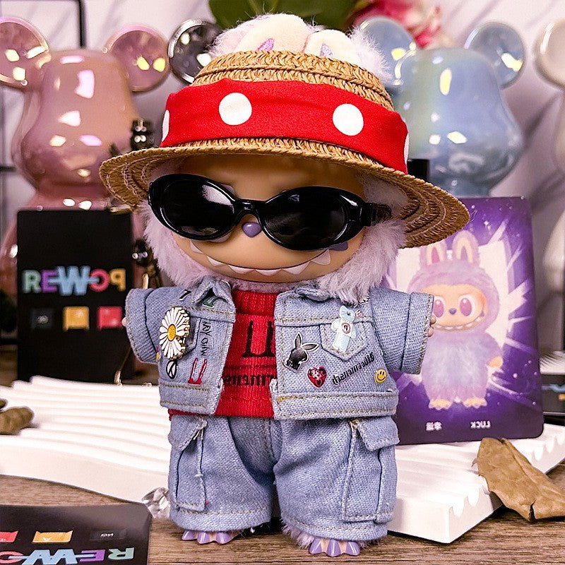 The ZoDoll Labubu Cool Street Denim Jacket Outfit Set features a plush toy with purple fur, sunglasses, a straw hat with a red band, and trendy denim clothes, displayed on a desk amid vibrant decorations.