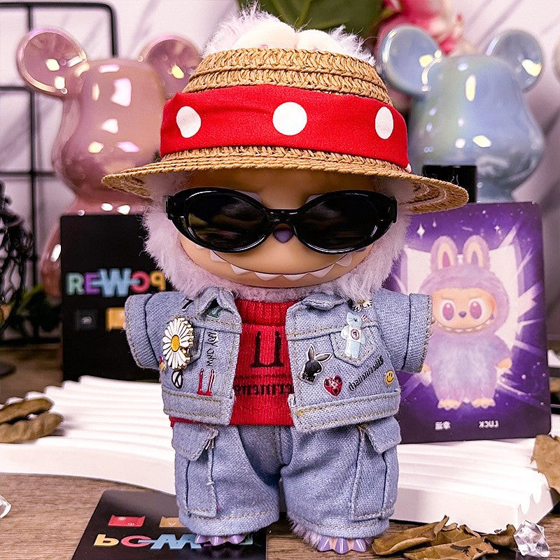 The ZoDoll Labubu Cool Street Denim Jacket Outfit Set, featuring a straw hat and sunglasses, stands on a desk surrounded by decorative items and cards.