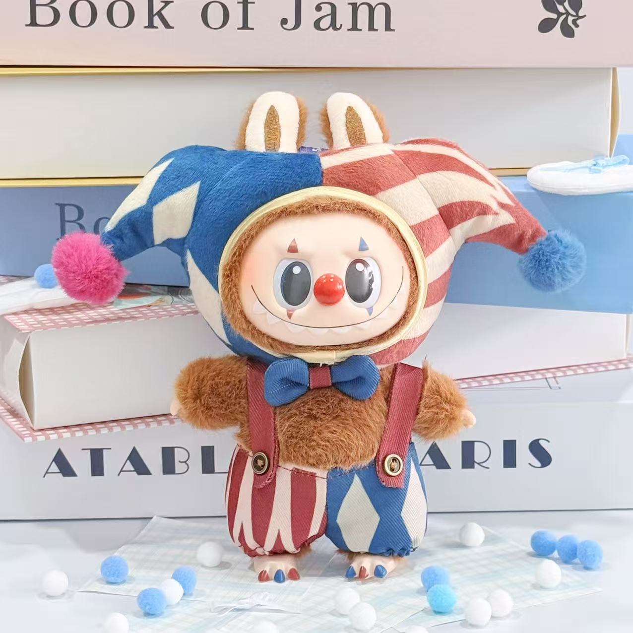 The ZoDoll Labubu Jester Clown Doll Costume features a blue and red harlequin circus outfit with a bow tie and suspenders—an adorable collectible for Pop Mart fans.
