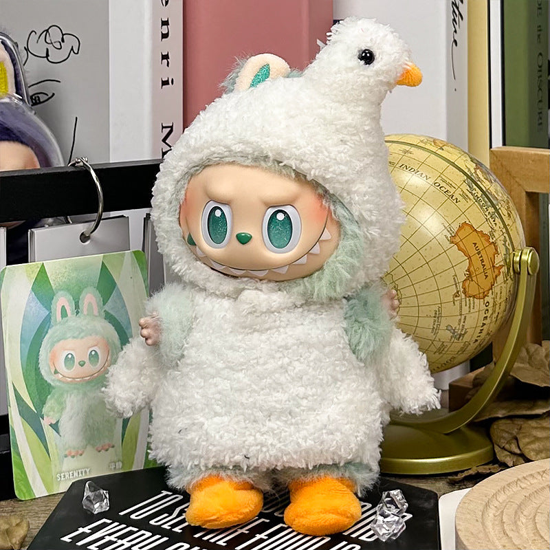 The ZoDoll Labubu White Fluffy Bird Kigurumi Doll Costume Set features a doll with big green eyes in a white bouclé loop bird suit with orange feet, posed beside a globe and a matching illustrated card.