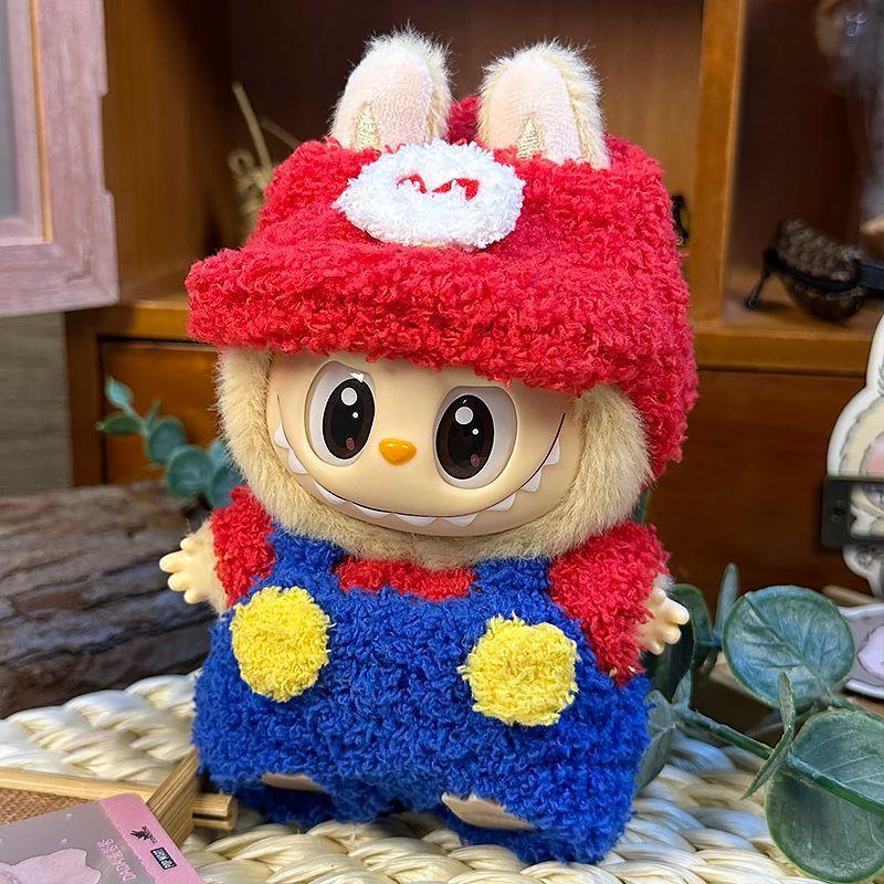 The ZoDoll Labubu Fluffy Plumber Costume Set features a plush Labubu doll with large eyes, wearing a red cap with bunny ears and an “M”, plus blue overalls with two yellow buttons.