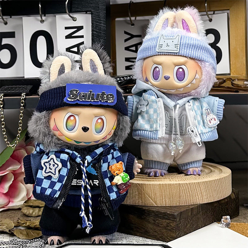 Two ZoDoll Labubu dolls in Navy Streetwear Sets with salute beanies and checkerboard scarves stand on a table, surrounded by a decorative calendar and flowers.