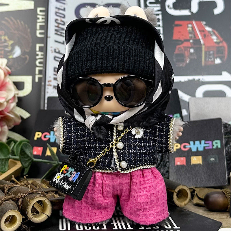 The ZoDoll Labubu Designer Tweed Jacket and Hot Pink Pants Luxury Doll Outfit Set features a stylish Labubu plush in sunglasses, a black beanie, scarf, plaid jacket, and pink pants among chic decor.
