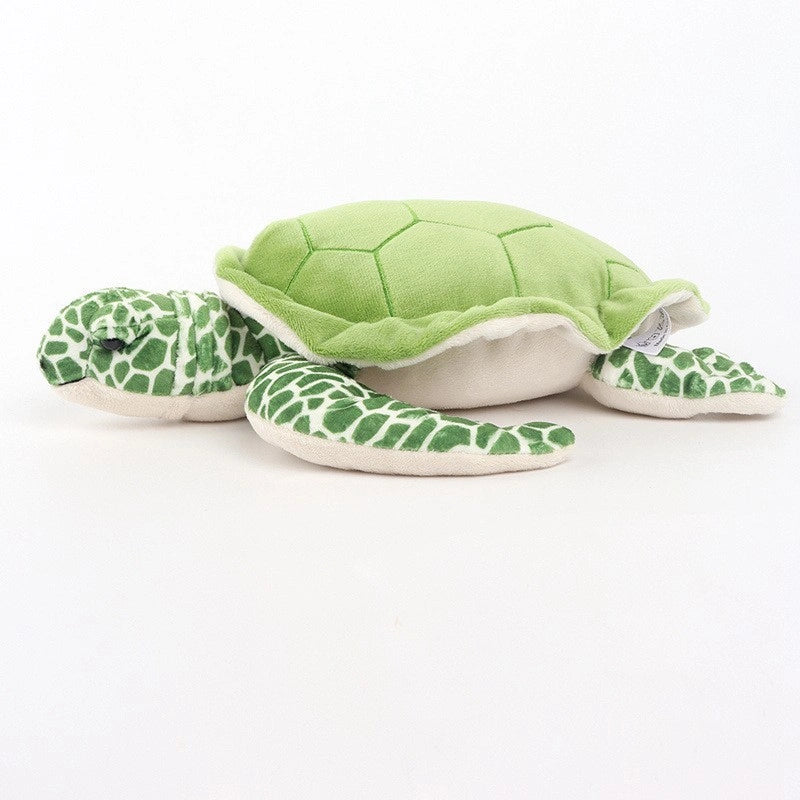 The ZoDoll Sea Turtle Plush Toy is a soft, green and white stuffed animal pillow (25x30cm) featuring a hexagonal shell pattern and spotted limbs, shown lying on a plain white background.