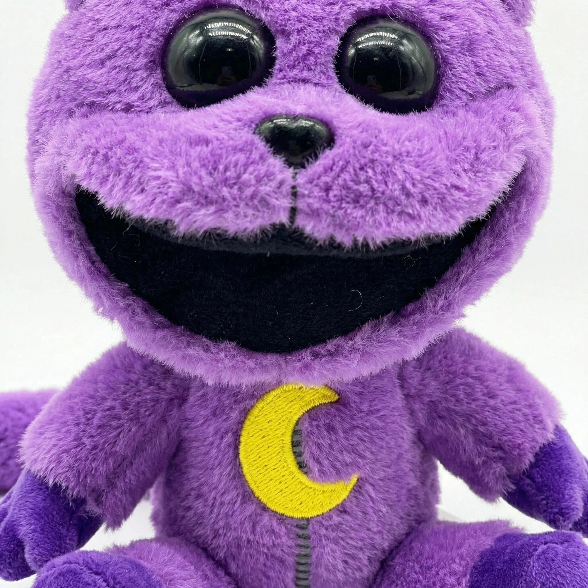 A Poppy Playtime CatNap plush from the Monster & Nightmare collection, featuring purple fur, large black eyes, a wide open mouth, and a yellow crescent moon on its chest. Four styles available.