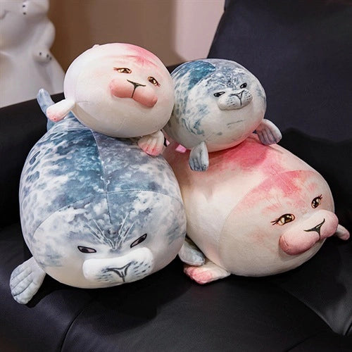 Three ZoDoll Seal Plush Toys—a 20cm and a 40cm chubby seal plush pillow—feature adorable detailed faces, arranged on a black surface.
