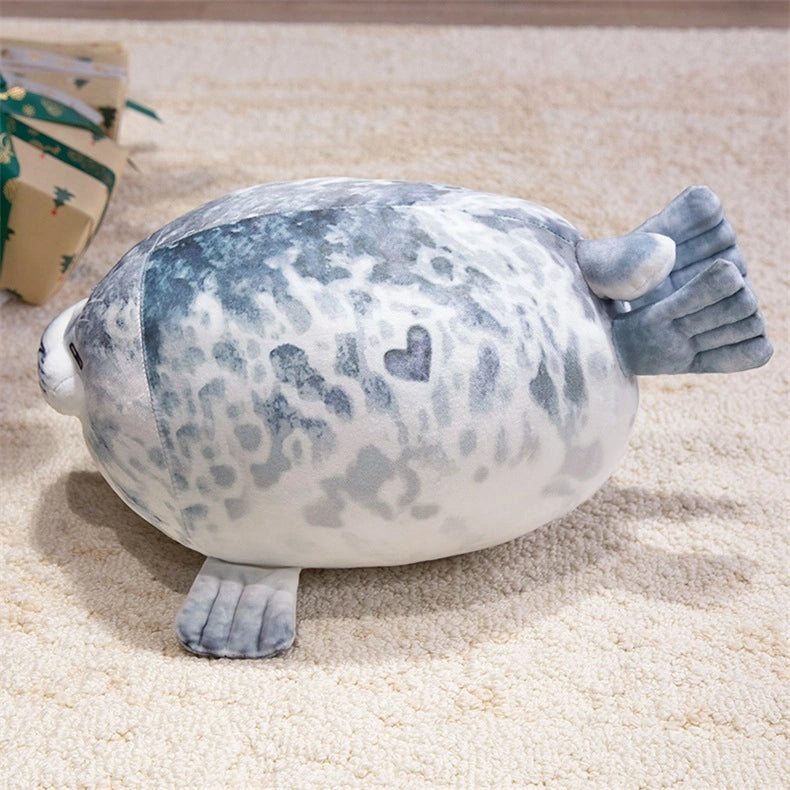 The ZoDoll Seal Plush Toys are cute, chubby seal plush pillows in soft grey and white, featuring heart-shaped markings. Available in 20cm or 40cm sizes, these stuffed seal animals add charm and comfort to any room.