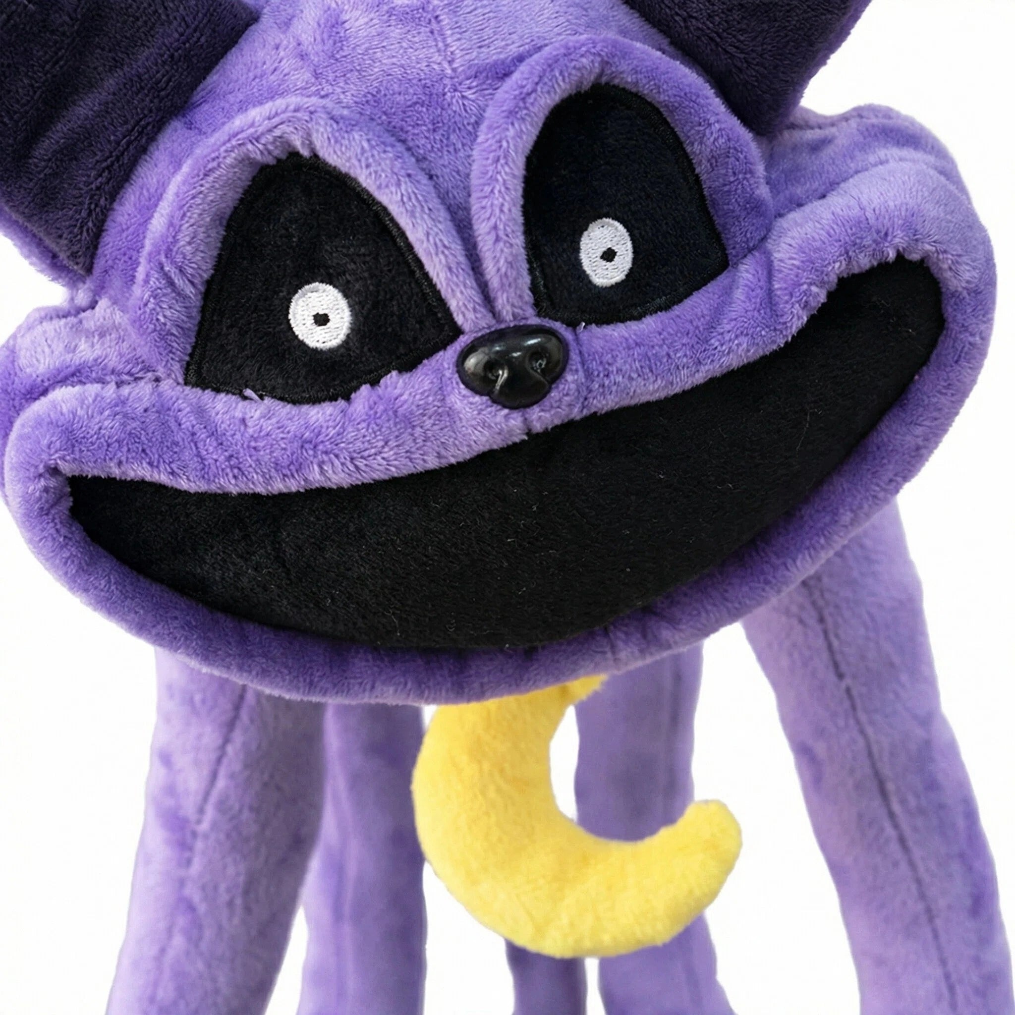 The Poppy Playtime CatNap Plush features large black eyes, a wide black smile, and a yellow crescent moon on its chest. Available in 4 styles from the official Poppy Playtime brand as Monster & Nightmare CatNap plush toys.