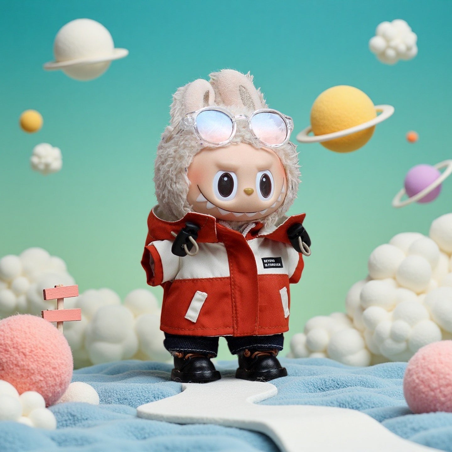 A ZoDoll Labubu plush doll in a Red Explorer Jacket outfit set with gloves and boots stands on a blue and white surface, surrounded by pastel planets and clouds.