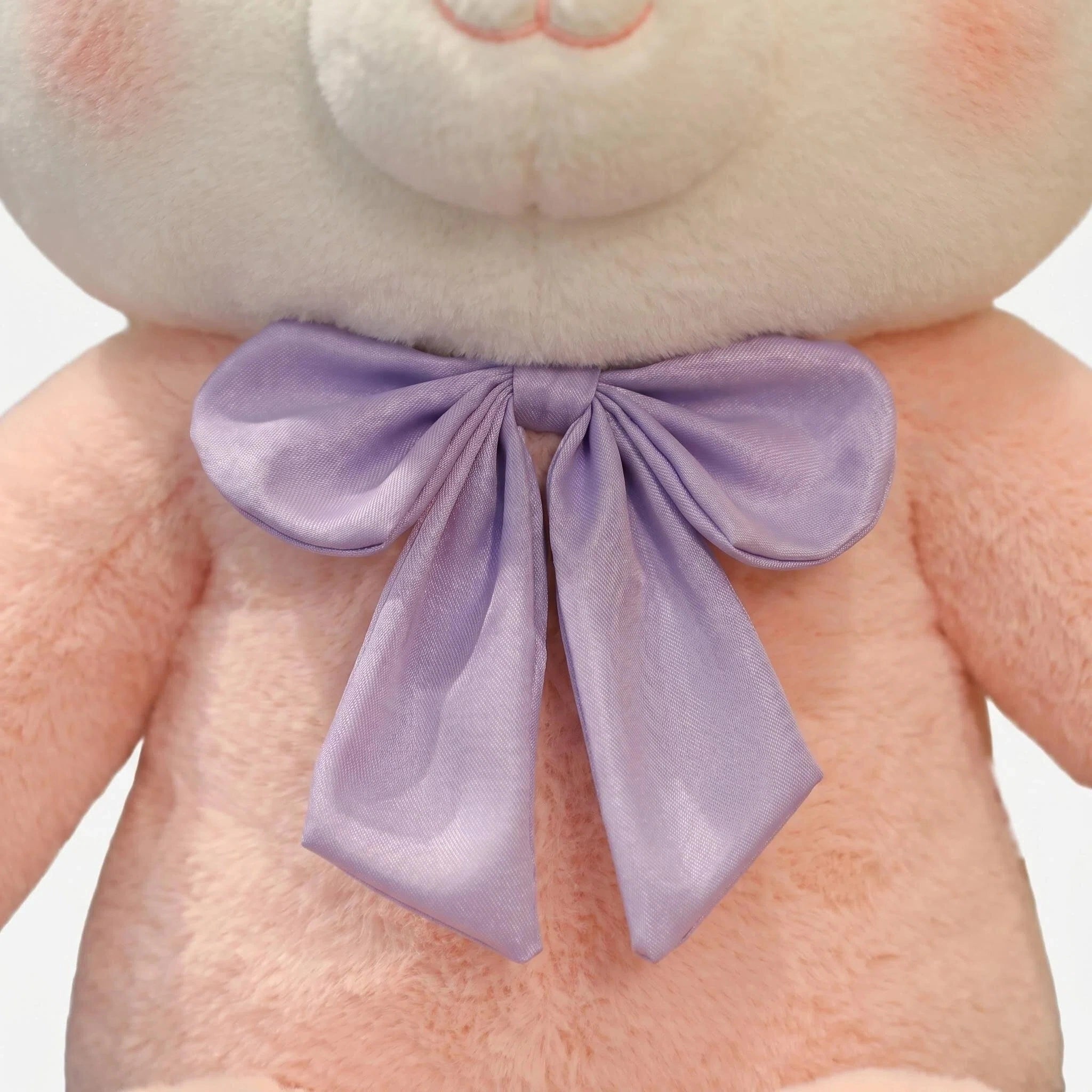 Close-up of ZoDoll’s Pink Fox Plush, a cute fox plush doll with light pink fur, a large lavender bow, and a kawaii face—an irresistibly adorable stuffed animal.