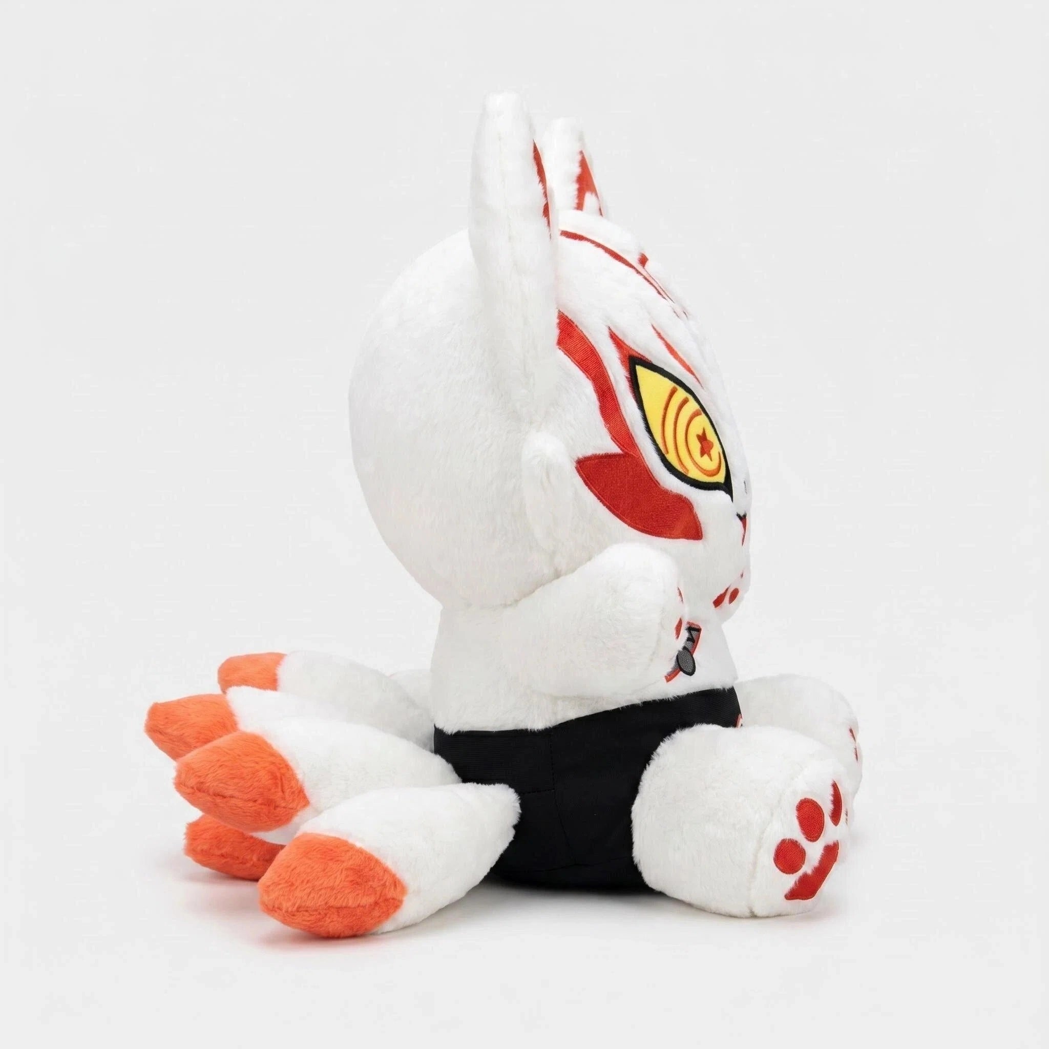The ZoDoll White Fox Plush Toy features red markings, big ears, orange-tipped tails, and black shorts—shown sitting in profile against a plain background. A must-have plush for any fox stuffed animal collection!.