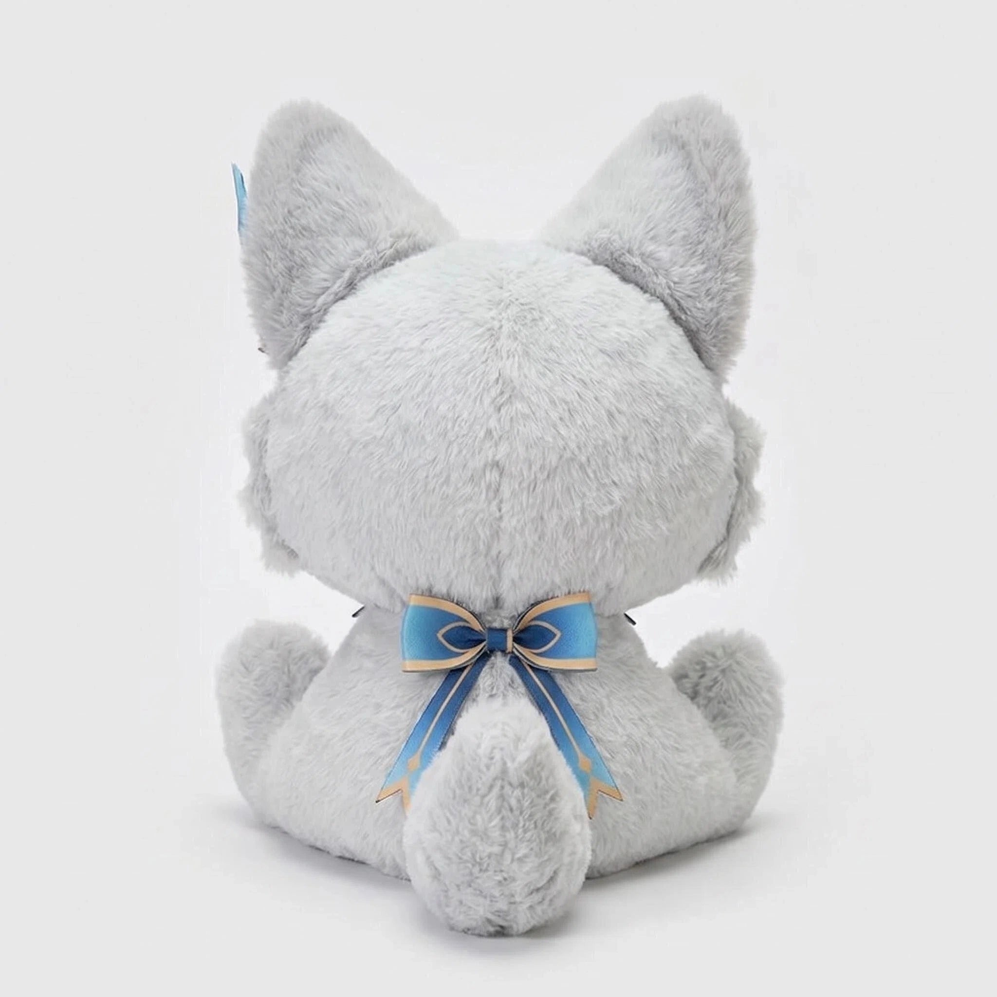 The ZoDoll Gray Fox Plush Toy, a cute silver fox stuffed animal with anime eyes and big ears, is shown from the back with upright ears and a blue ribbon tied in a bow around its neck.