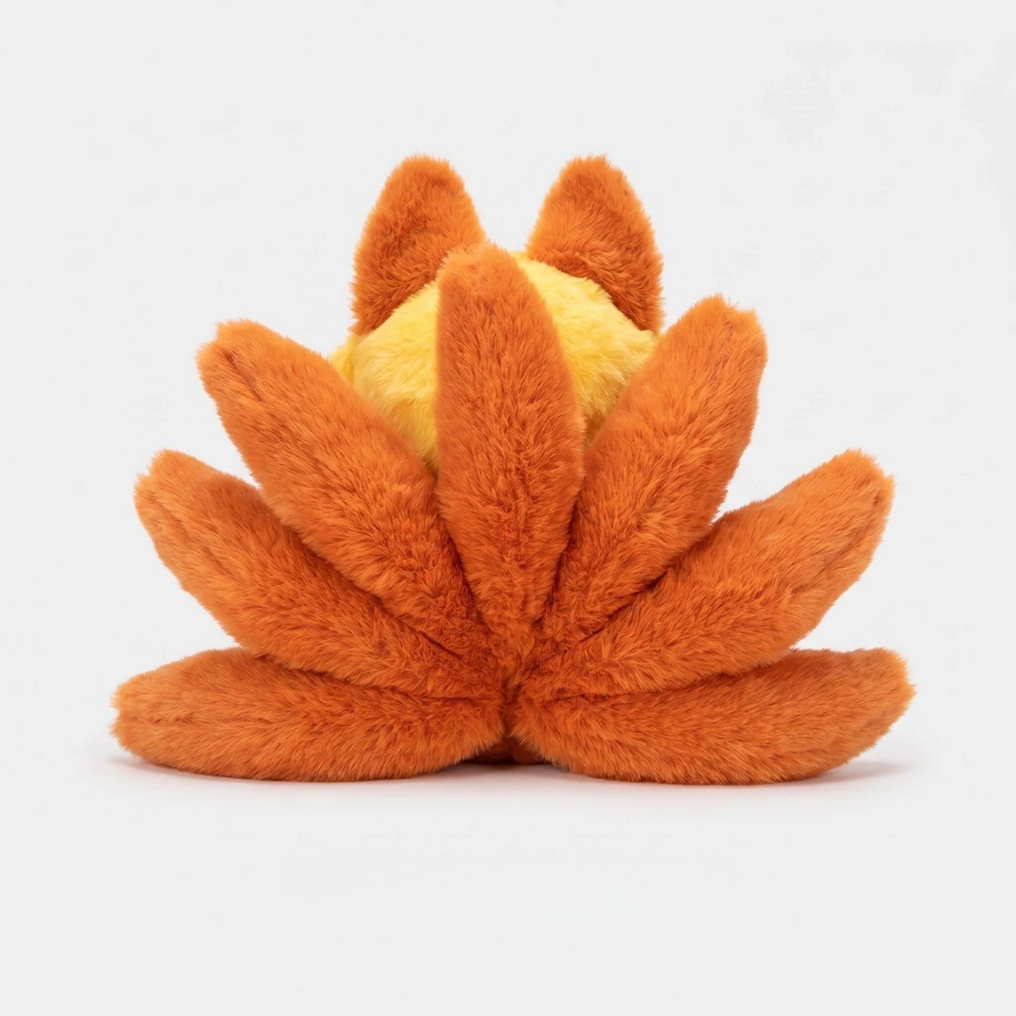The ZoDoll Nine Tailed Fox Plush is a cute anime fox plush toy featuring nine orange, furry tails in a fan shape and a blond character design, shown with its round body partially visible from the back against a white background.